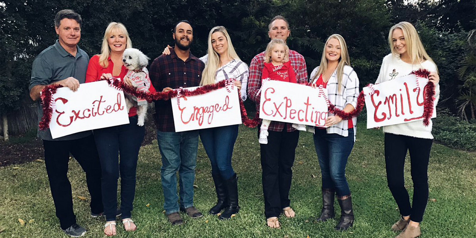Family holding signs for Christmas card, Excited, Engaged, Expecting, Emily