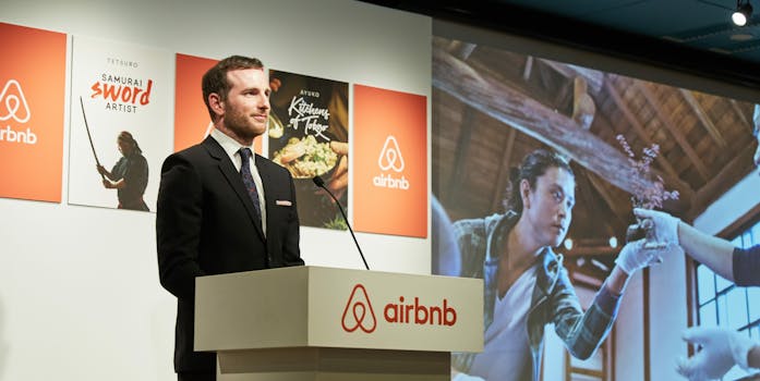 Airbnb representative talking onstage