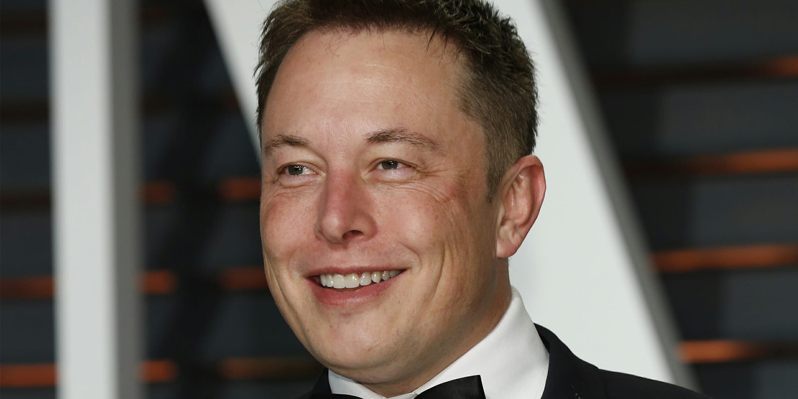 Elon Musk in tuxedo, smiling