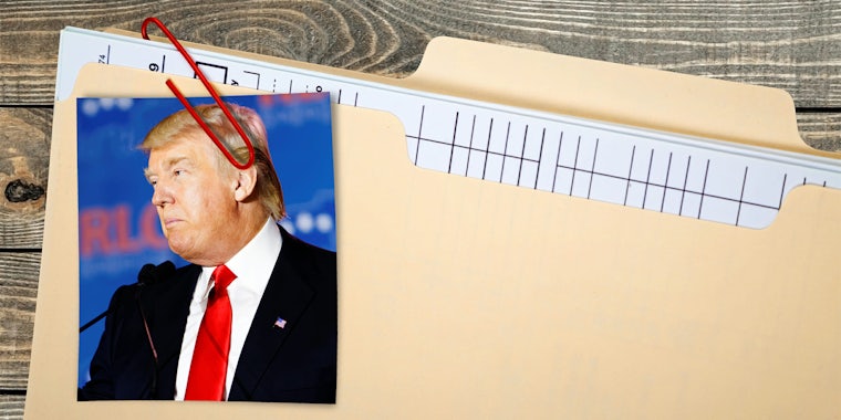 Donald Trump picture paperclipped to a manila folder filled with papers