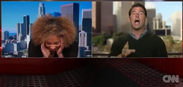 Amanda Seales with her head in her hands.