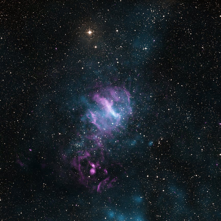 "MSH 11-62: When X-rays, shown in blue, from Chandra and XMM-Newton are joined in this image with radio data from the Australia Telescope Compact Array (pink) and visible light data from the Digitized Sky Survey (DSS, yellow), a new view of the region emerges. This object, known as MSH 11-62, contains an inner nebula of charged particles that could be an outflow from the dense spinning core left behind when a massive star exploded."