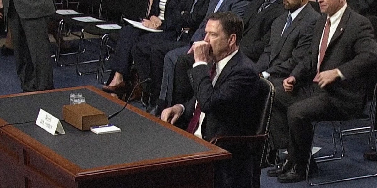James Comey with Hand Over Mouth