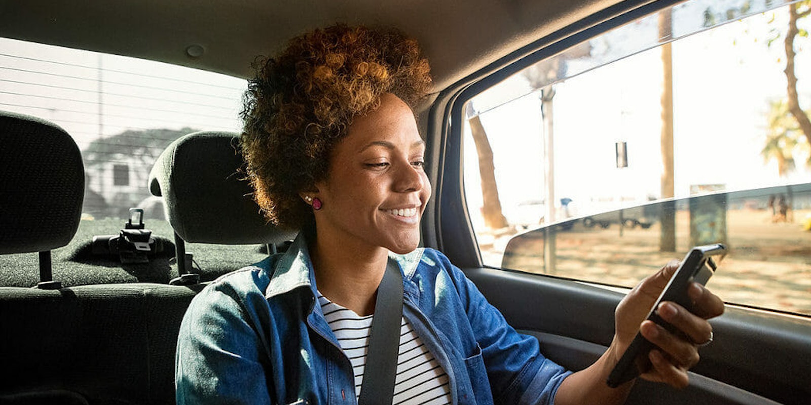 Woman in Uber smiling