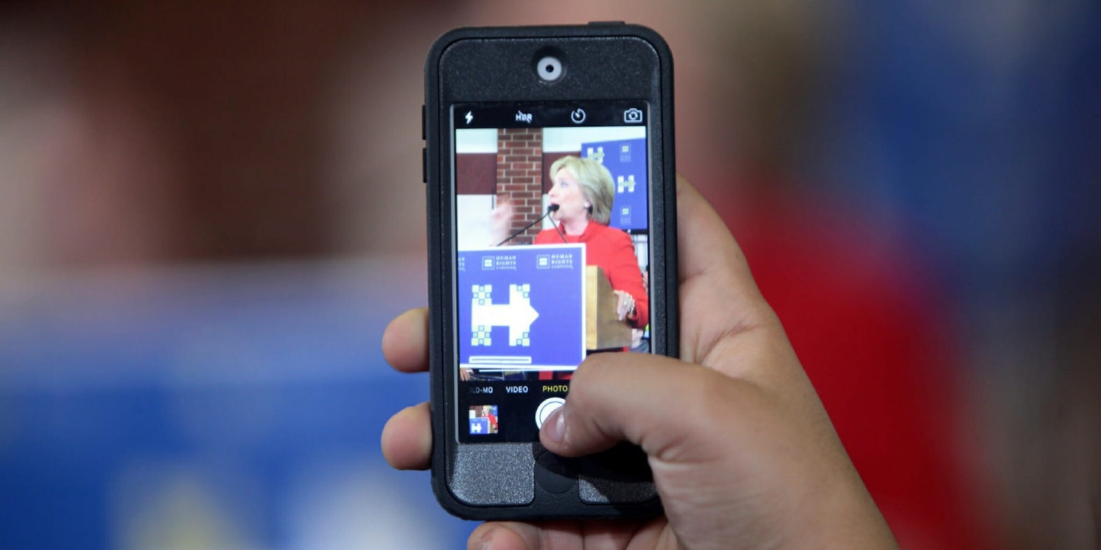 An iPhone taking a photo of Hillary Clinton
