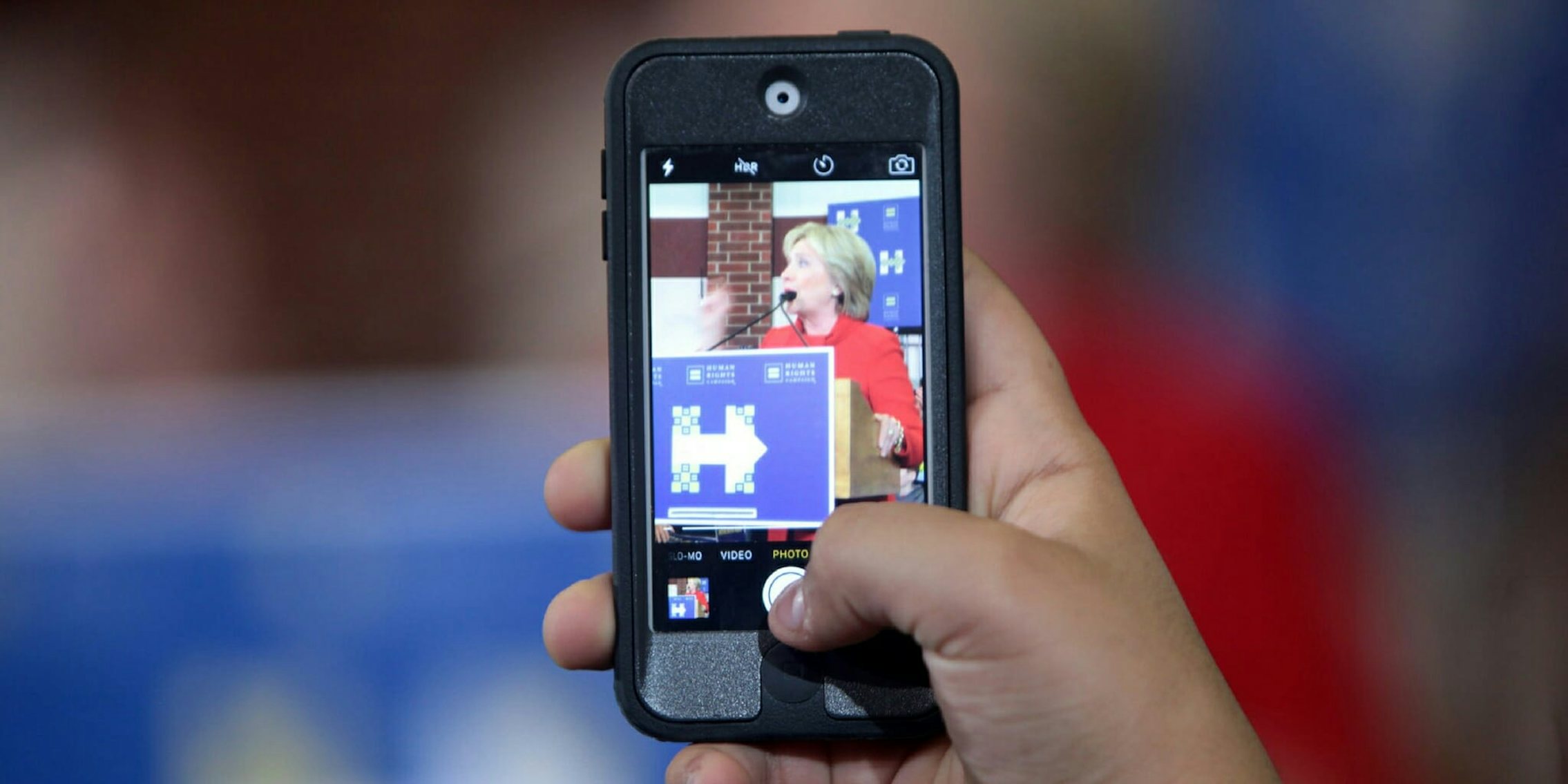 An iPhone taking a photo of Hillary Clinton