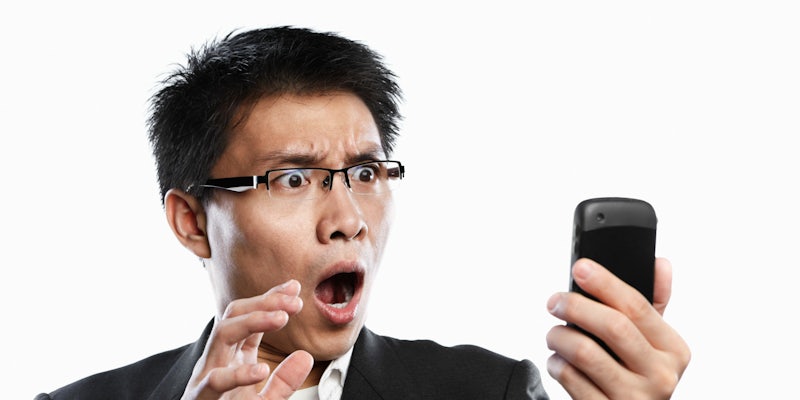 A man stares shocked at his phone screen.