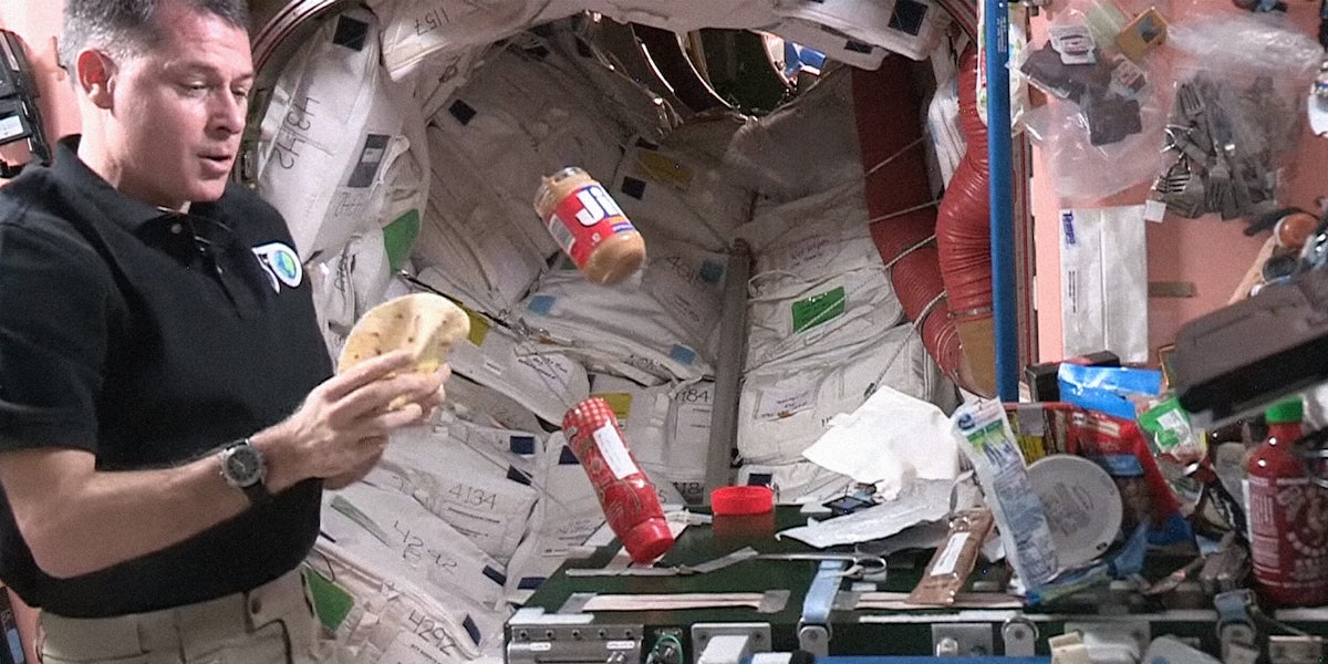 Astronaut making peanut butter and jelly sandwich in space