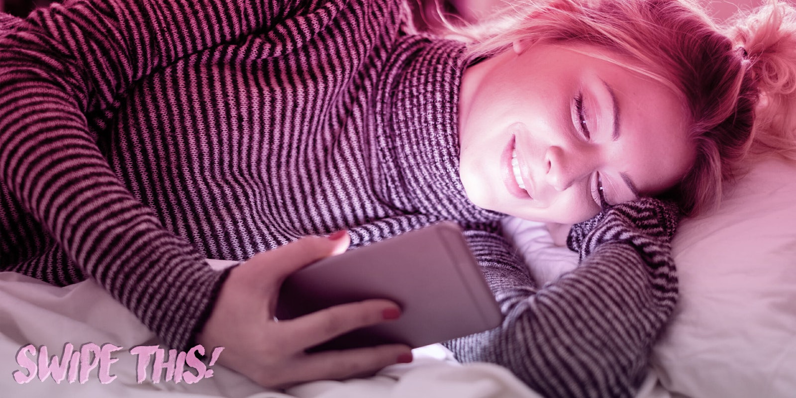 Woman looking at her phone in bed