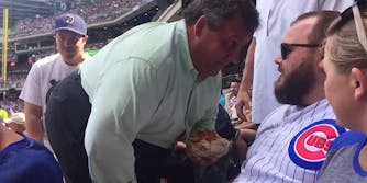 Chris Christie gets in a man's face at a Cubs game while holding nachos