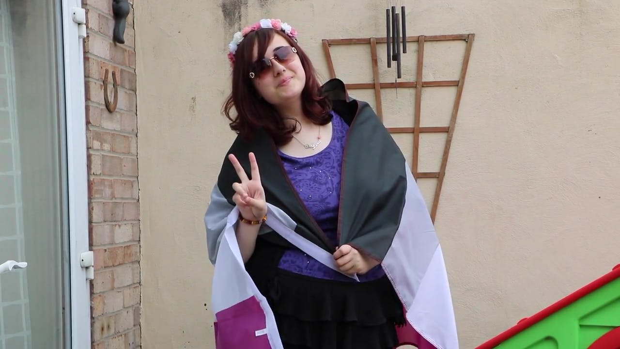 An asexual activist poses before an LGBTQ march.