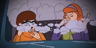 Velma and Daphne wave away smoke in the Mystery Machine
