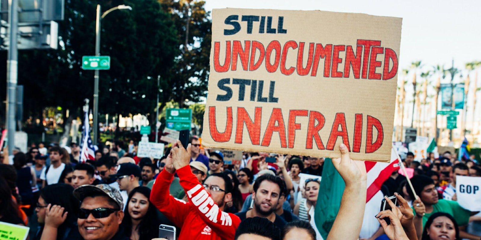 Protesters march for DACA in Los Angeles, one holding a sign that says, 'Still Undocumented, Still Unafraid.'