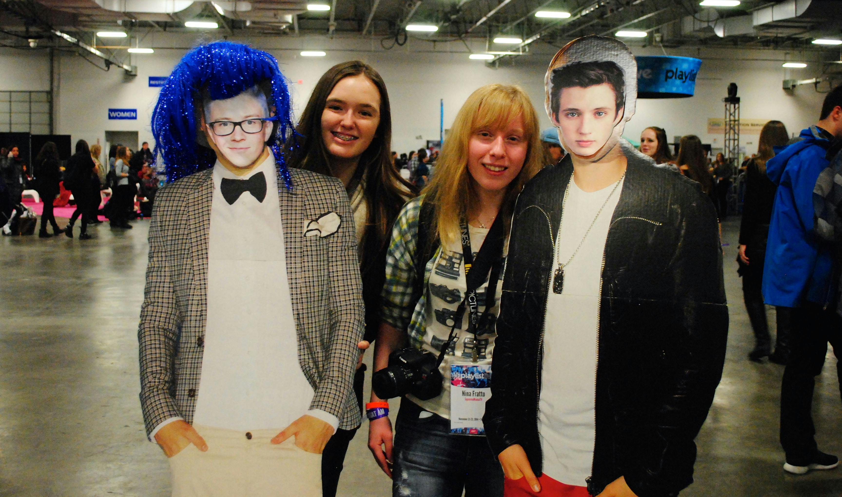 Fans pose with cutouts of Tyler Oakley and Troye Sivan