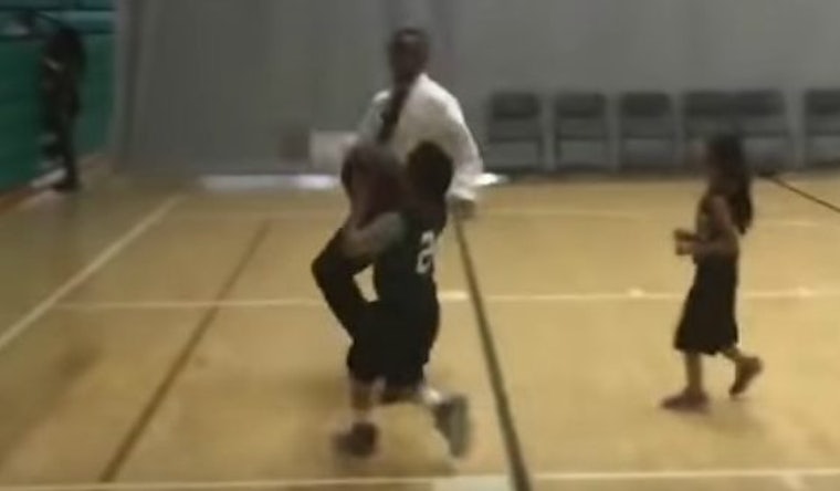 youth basketball player blocked coach