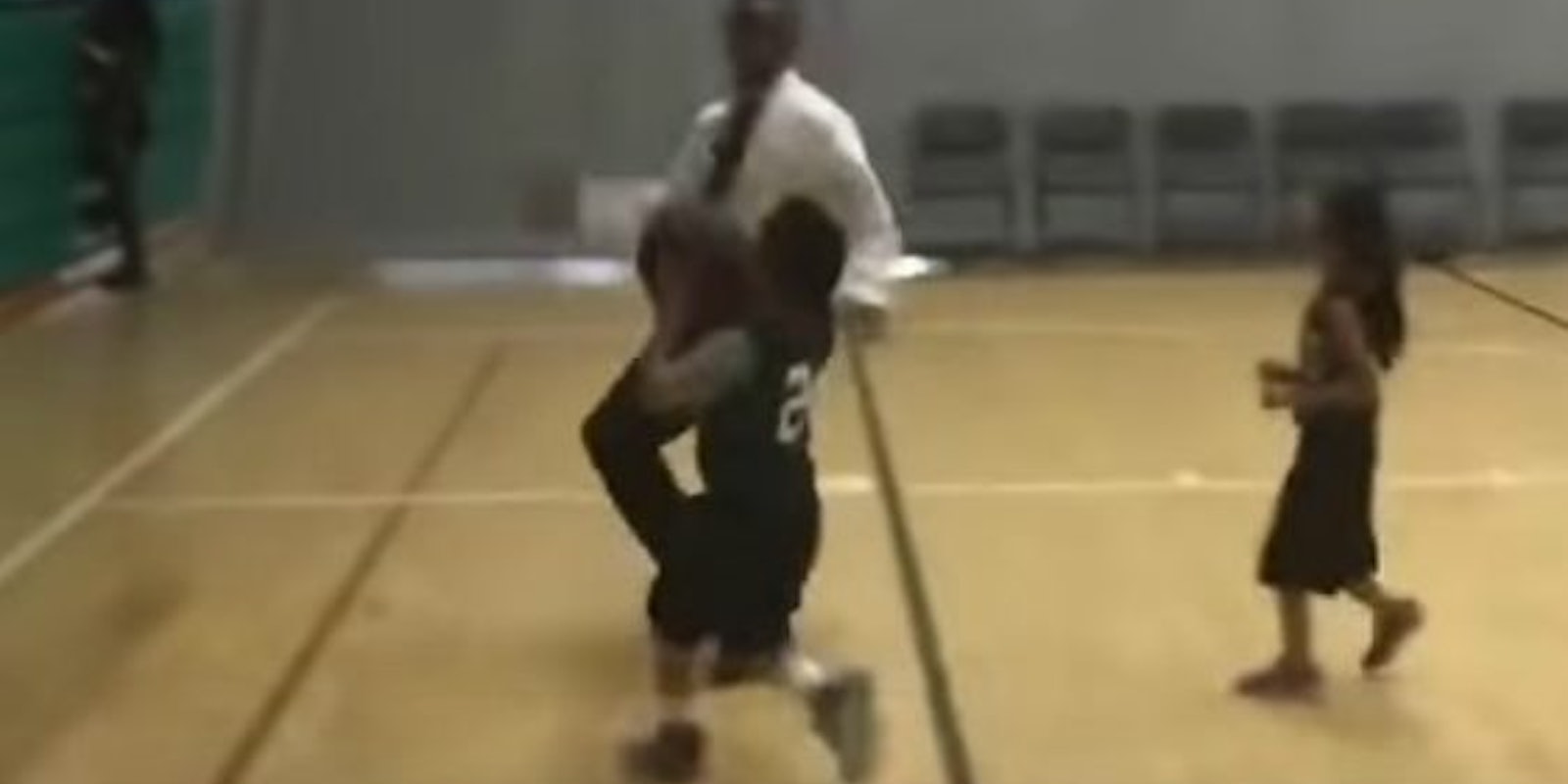 youth basketball player blocked coach