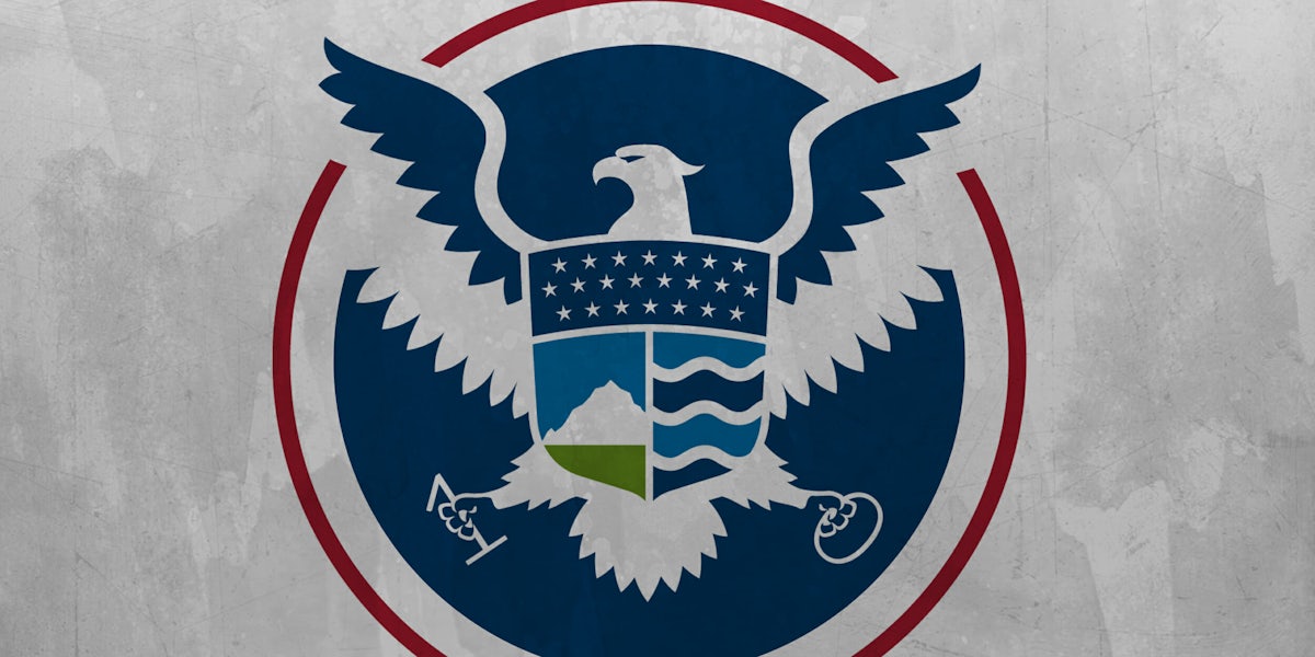 DHS logo holding 1 and 0 in place of arrows and olive branches