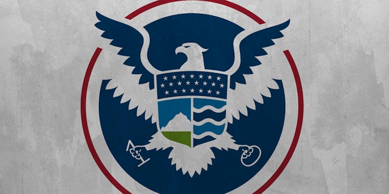 DHS logo holding 1 and 0 in place of arrows and olive branches