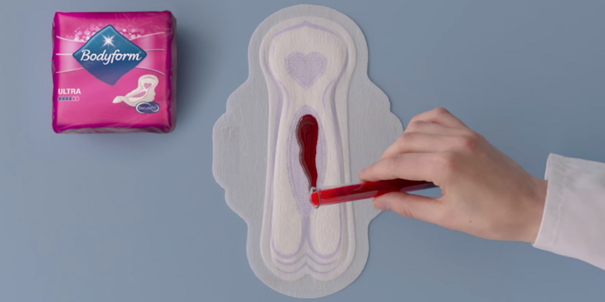 A period pad demonstration with red blood from an advertisement from Bodyform.