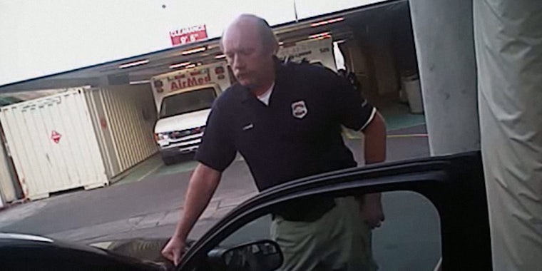 Disgraced Utah police officer leans on hood of squad car