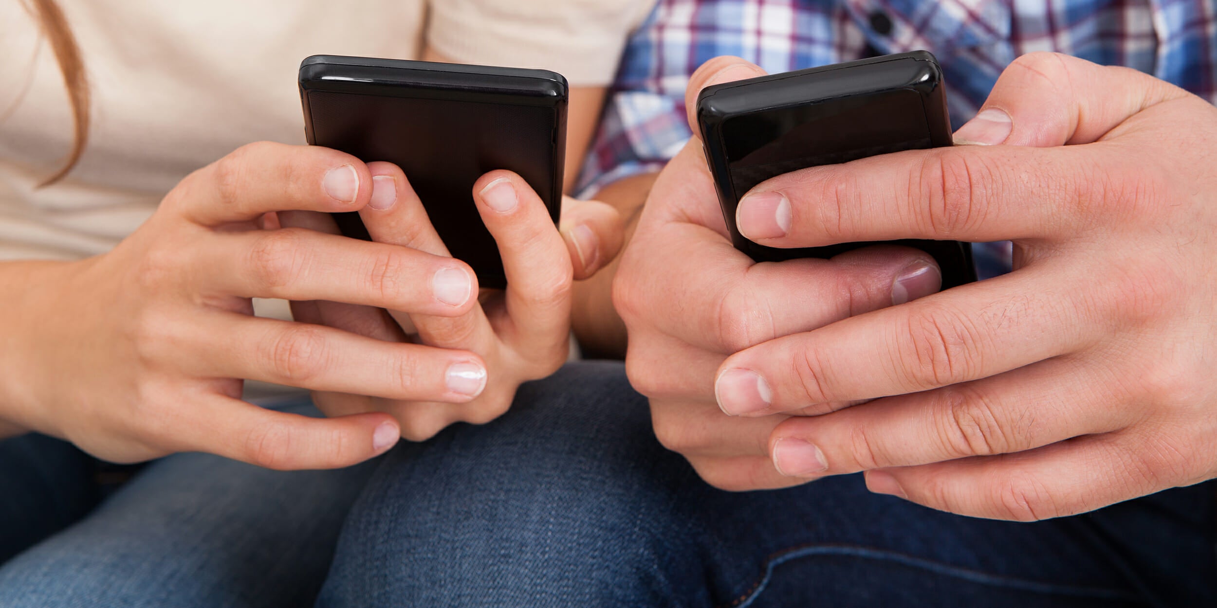 Couple using their smartphones