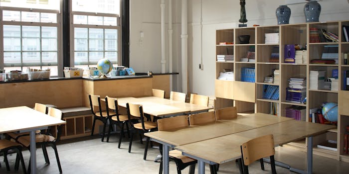 A school classroom full of empty desks.