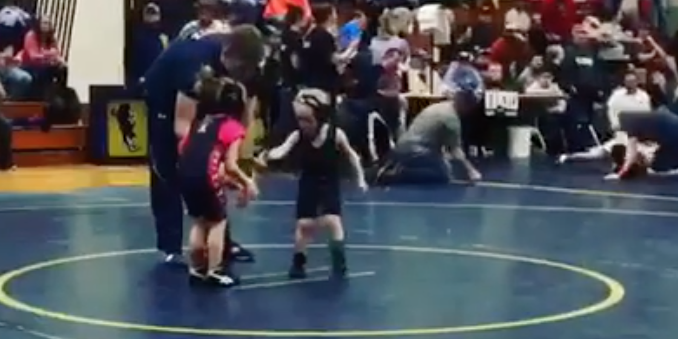 Little boy runs from 5-year-old girl in wrestling match