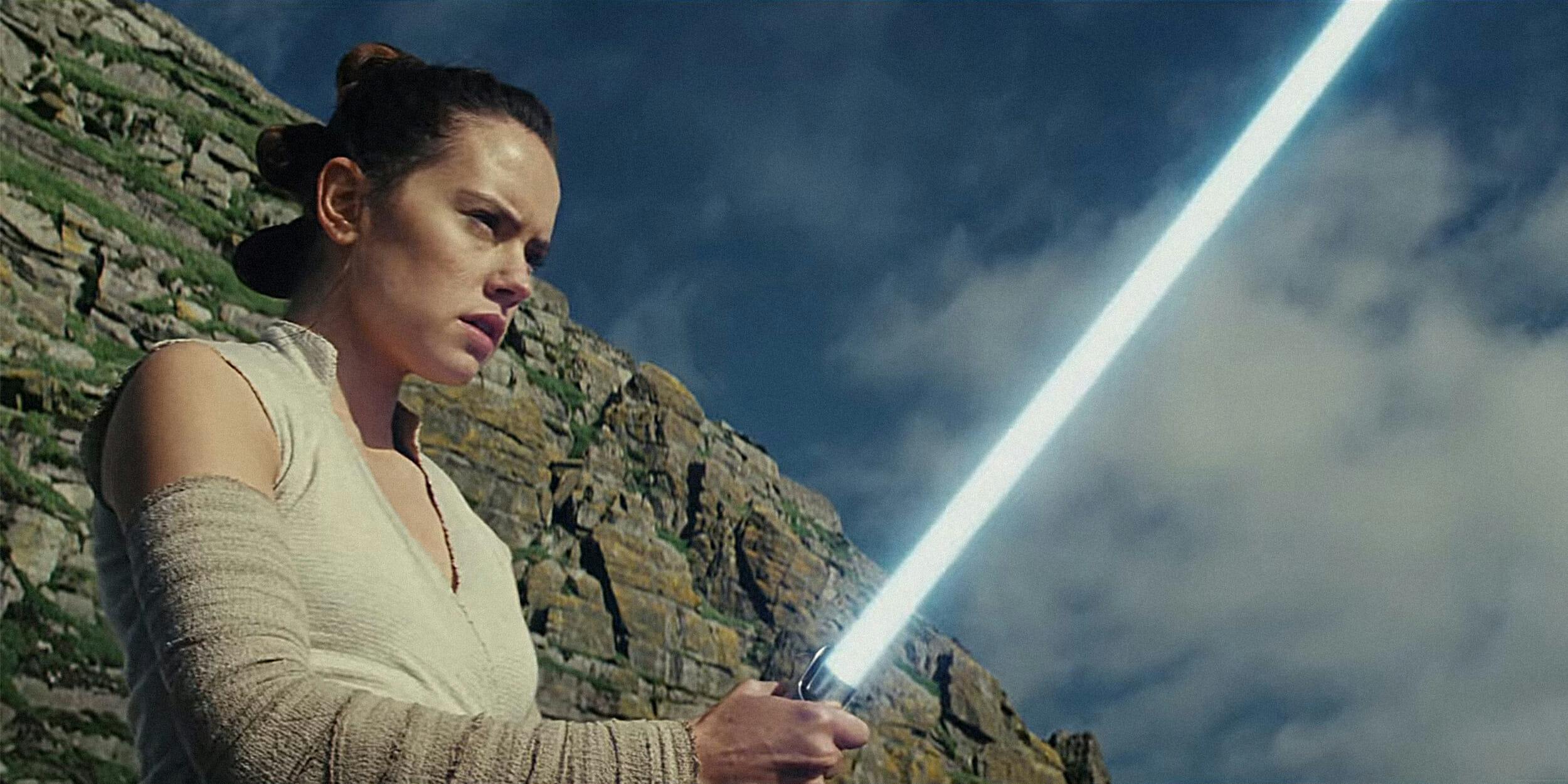 Rey from Star Wars swinging a lightsaber