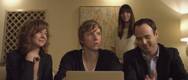 Four people sit around a laptop in a scene from what other couples do