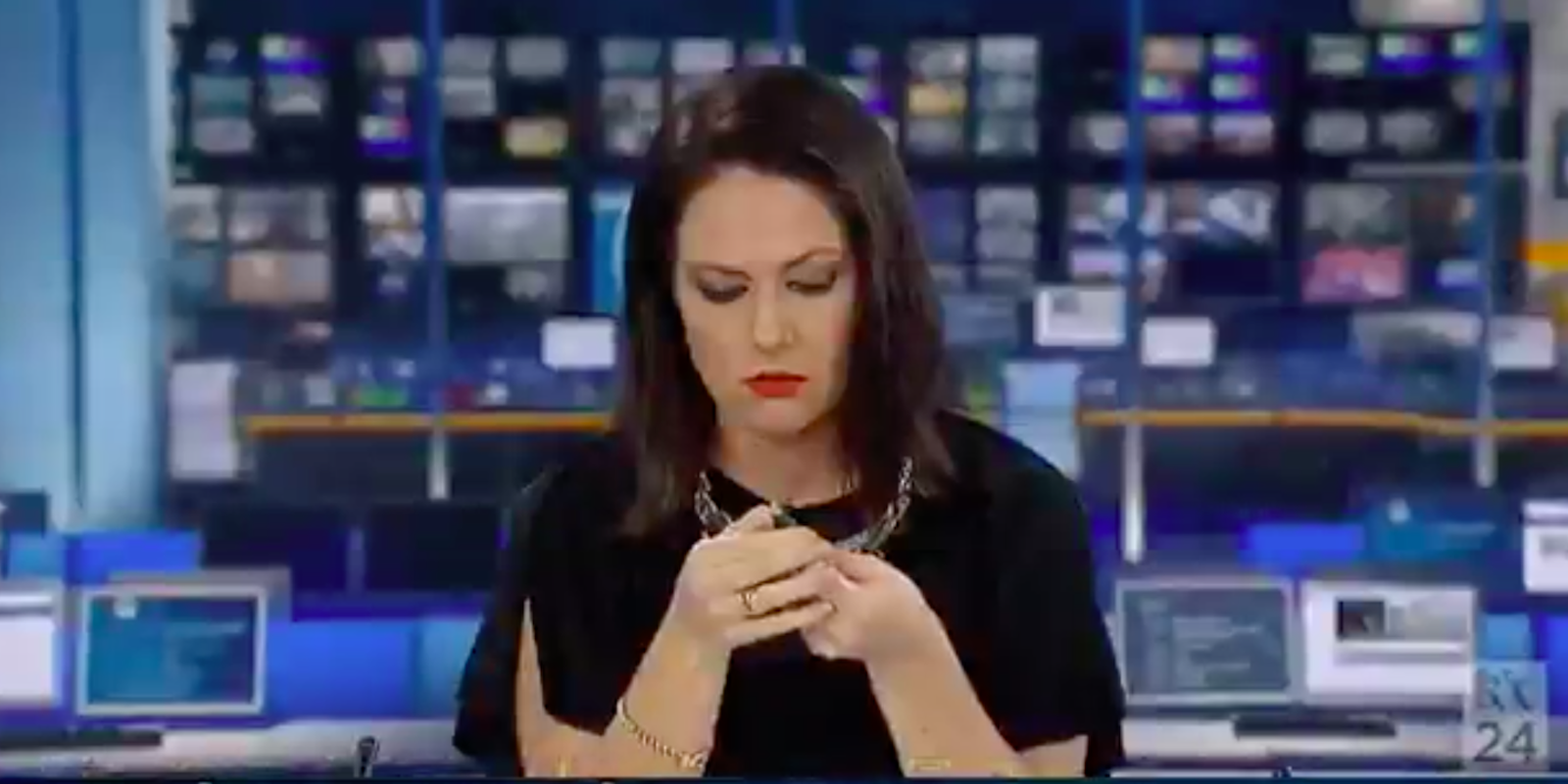 newscaster daydream on live television: picture of newscaster staring at her pen
