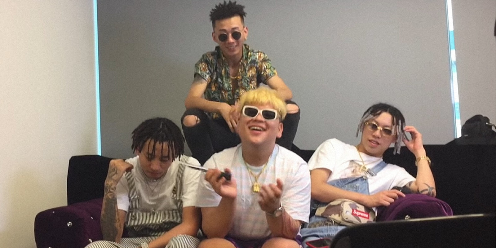 Higher Brothers relaxing on a couch