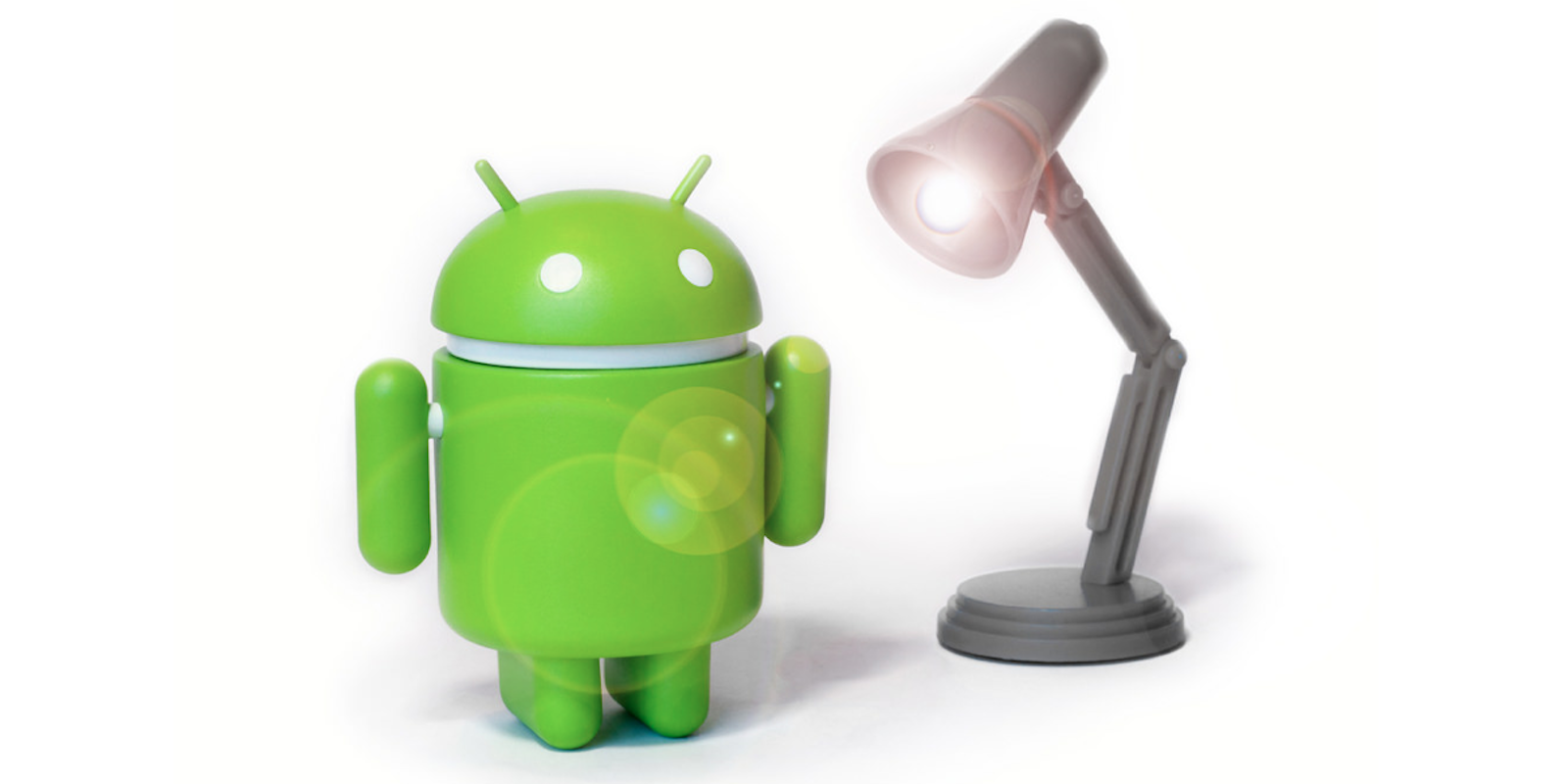 Android figurine next to lamp