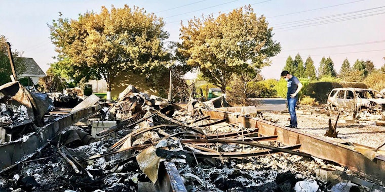 Kevin Kwan Loucks looks at the devastation wrought to his family's home as a result of the wildfires in California.