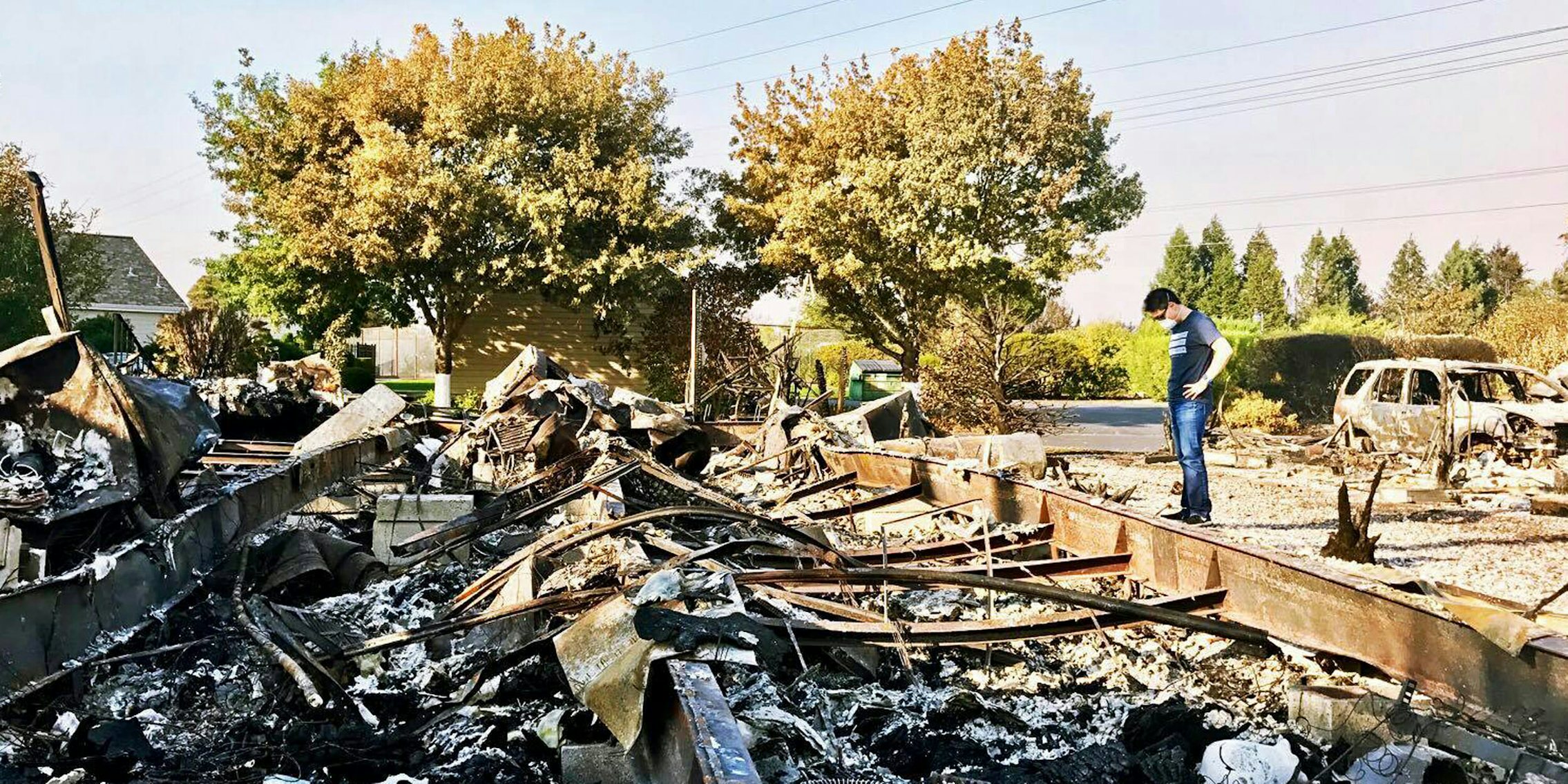 Kevin Kwan Loucks looks at the devastation wrought to his family's home as a result of the wildfires in California.