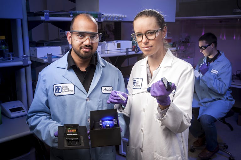 Zika virus testing: Male and female researchers holding Zika testing equipment