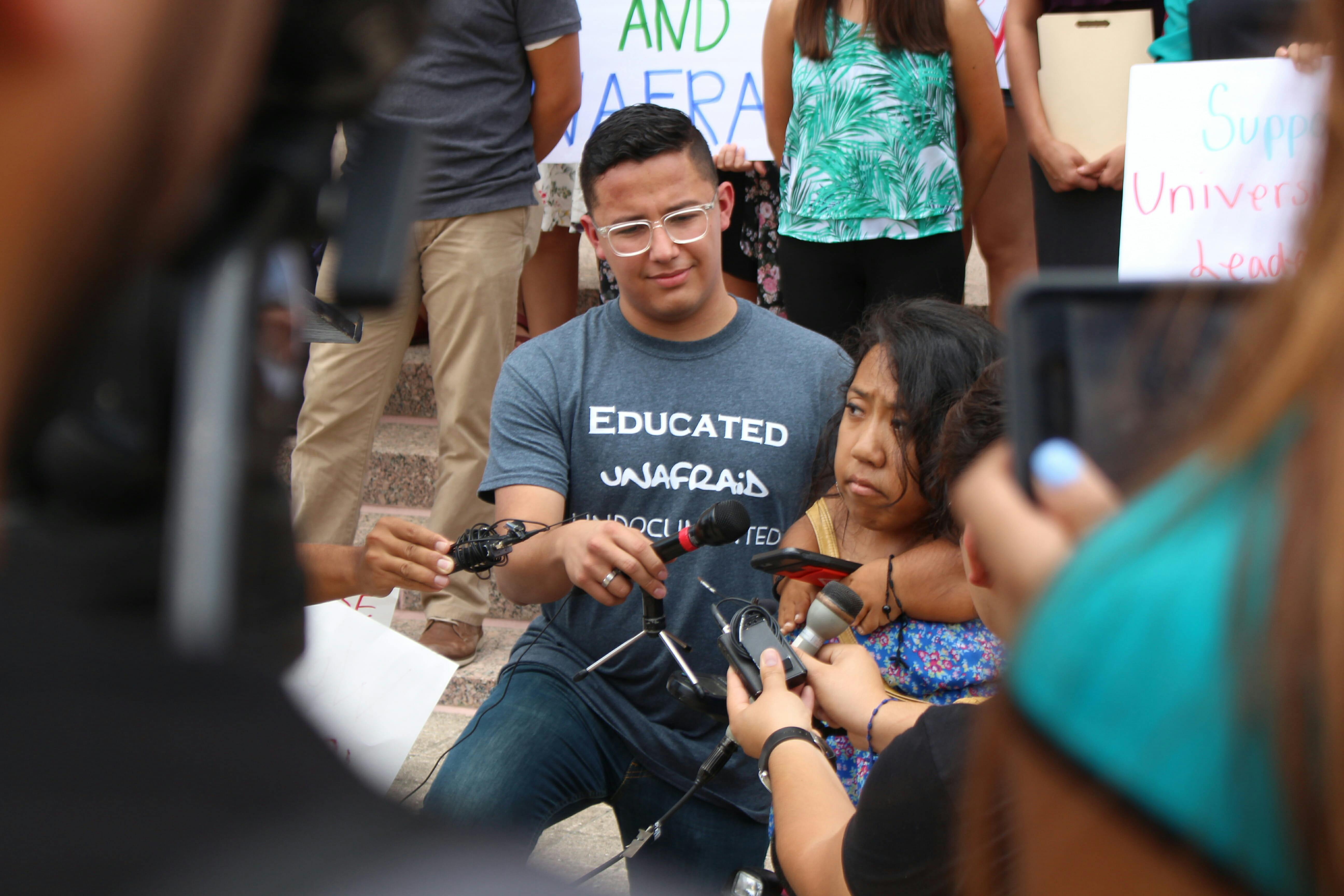 Sam Cervantes, a student leader with UT Austin's University Leadership Initiative, holds the microphone for UT Austin Student Government President Alejandrina Guzman. Guzman denounced President Donald Trump's resignation of the Deferred Action for Childhood Arrivals (DACA) Act on Sept. 5, 2017 in Austin, Texas.