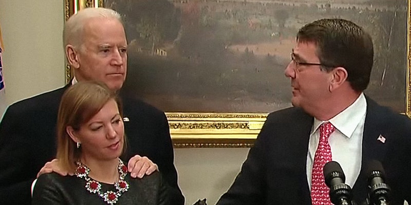 Joe Biden with his hands on Stephanie Carter's shoulders