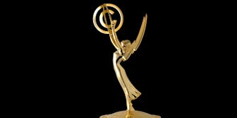 Emmy award statue holding copyright symbol