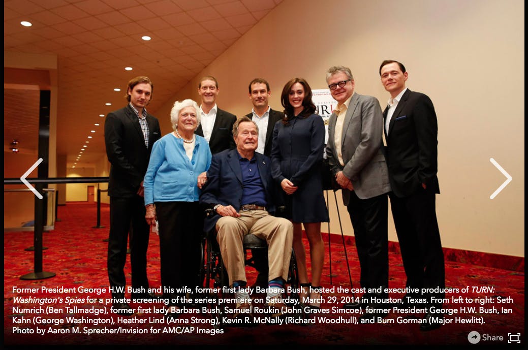 A photo of George HW Bush, Barbara Bush, and the cast and producers of Turn: Washington's Spies