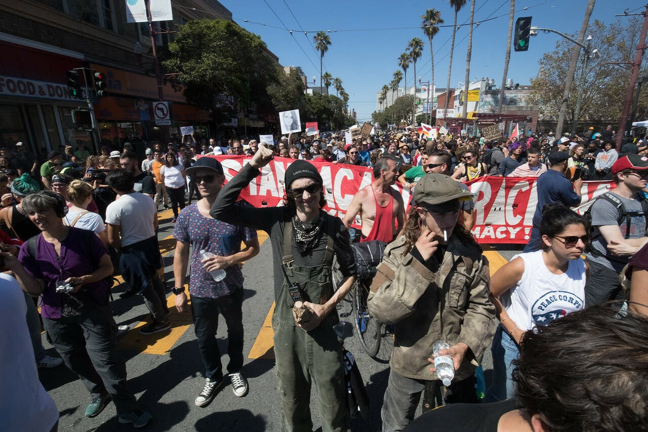 Antifa members John Cookenboo (center, with fist raised) and Vincent Yochelson (right, in green cap) attend an Aug. 26 anti-hate rally in San Francisco. The rally originally was planned as a counterprotest to a right-wing event at Crissy Field, but that gathering was canceled.