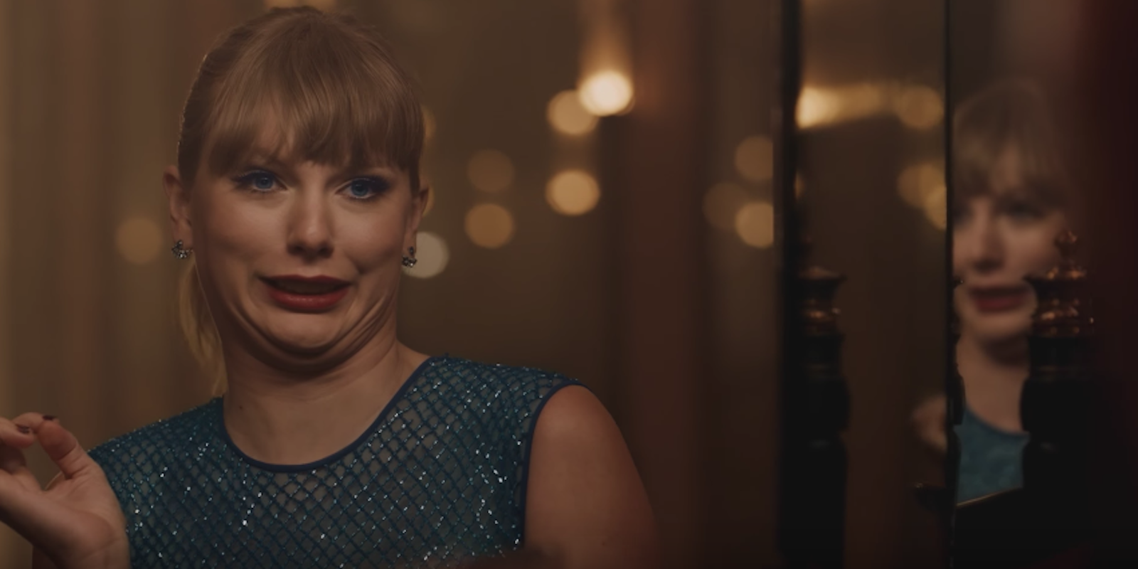 Taylor Swift makes a goofy face in the mirror