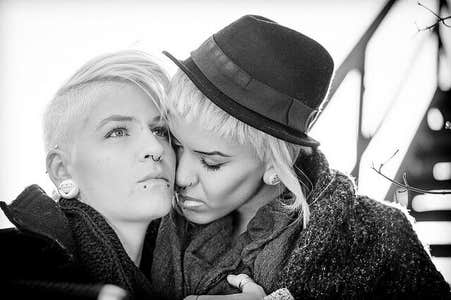 A lesbian couple shares an intimate moment together.