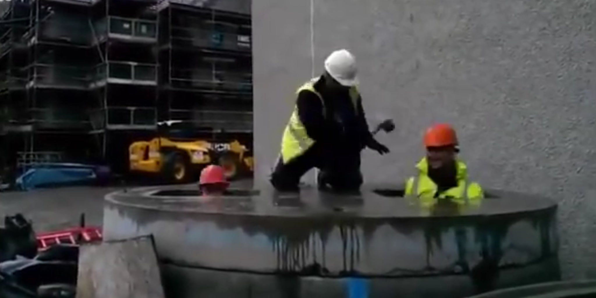 Construction workers take a break with a reallife game of whackamole