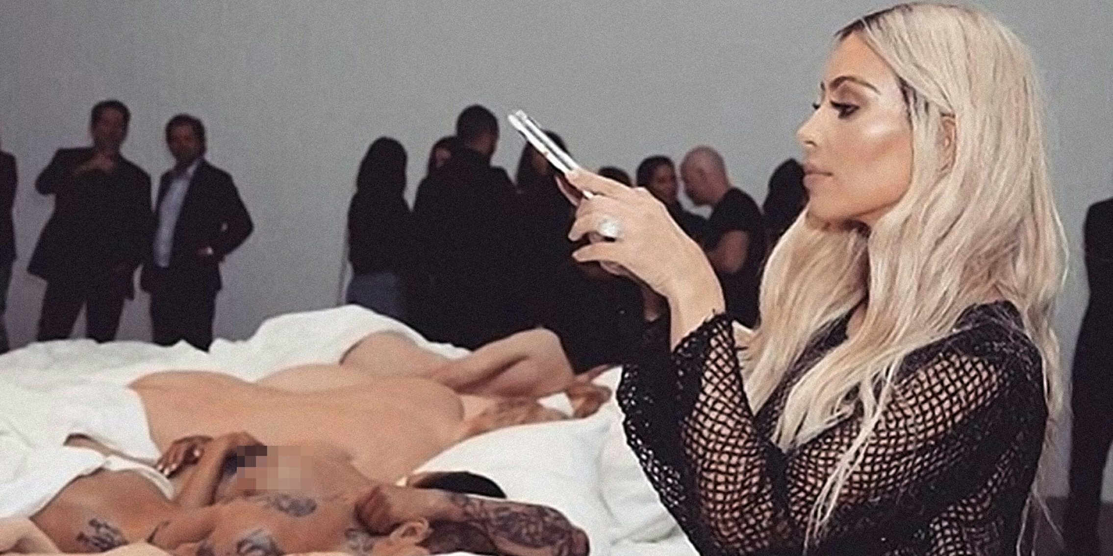 Kim Kardashian taking a picture of nude taylor swift wax sculpture