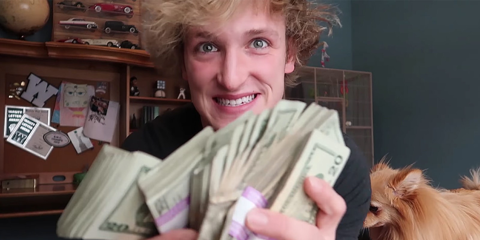 Logan Paul holding stacks of $20 bills