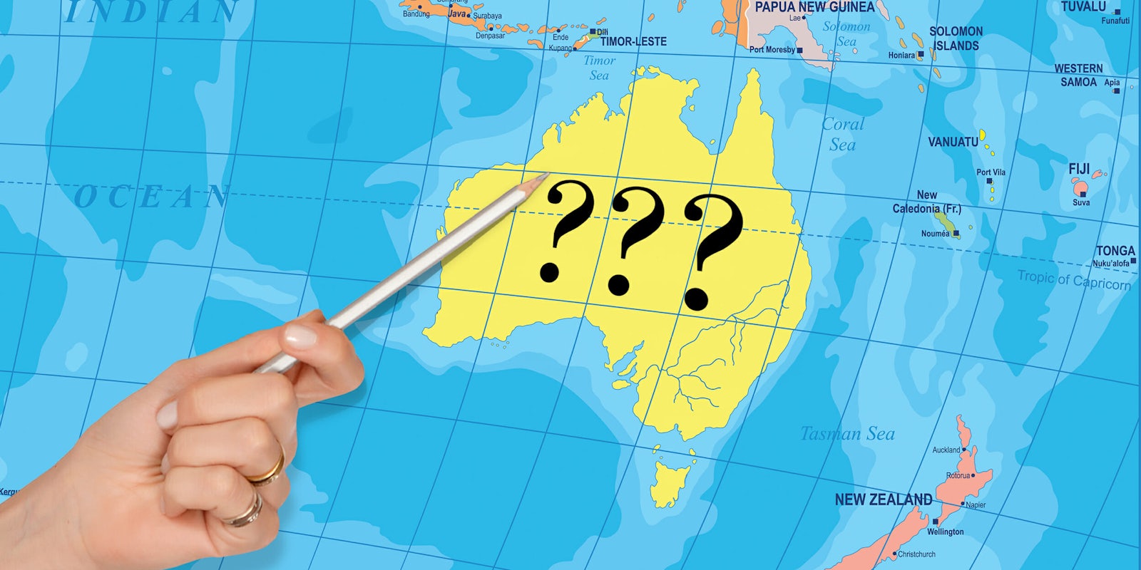 Hand pointing pencil to Australian continent labeled '???'