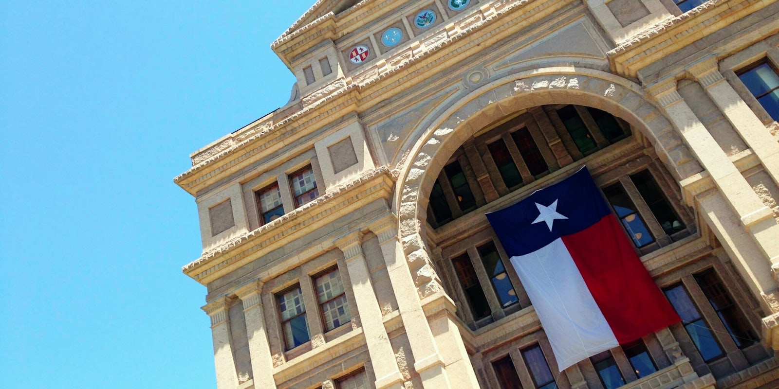 The Texas capitol with a Texas flag.