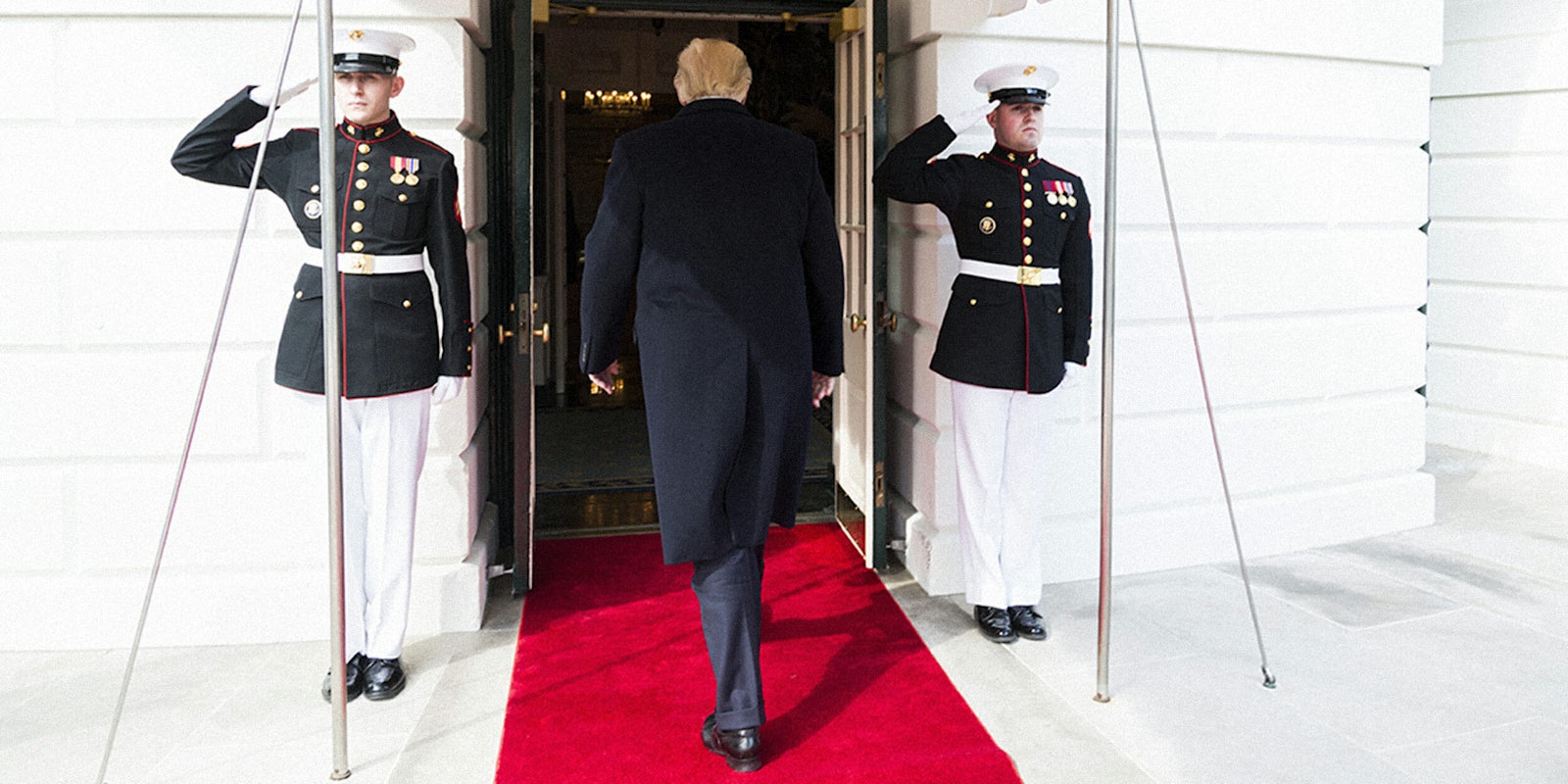 Donald Trump flanked by US Marines as he enters the White House