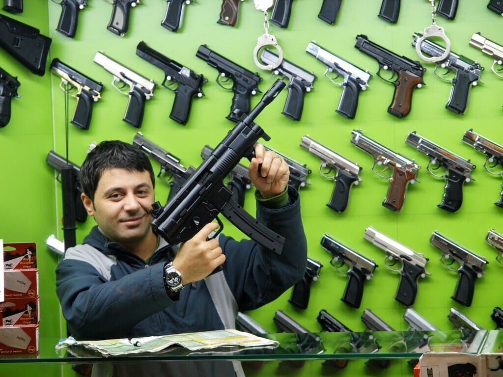 A man poses with a gun.