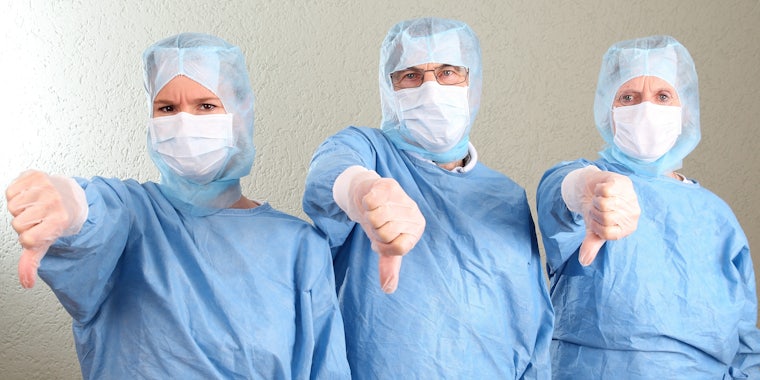Three Doctors Doing Thumbs Down